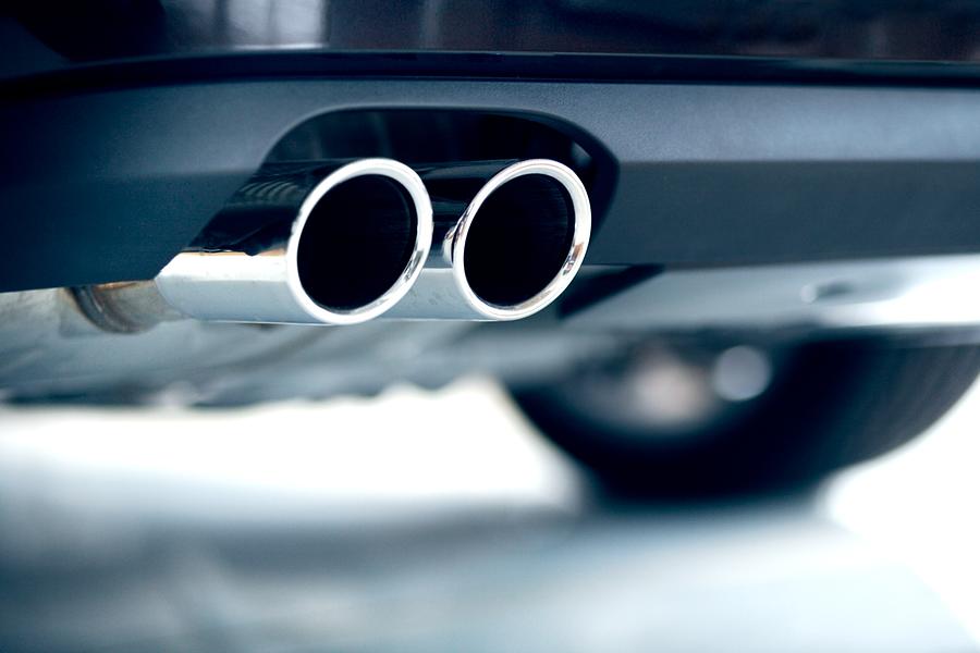 Stainless steel exhaust pipes on a blue car Photograph by Deepblue4you