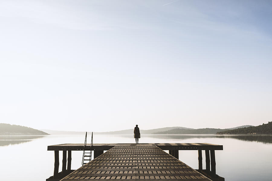 Standing on the seaside jetty Photograph by Ekin Kizilkaya