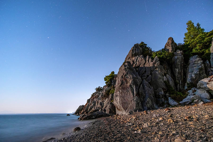 Starry Sky Over a Pebbled Beach Photograph by Alexios Ntounas