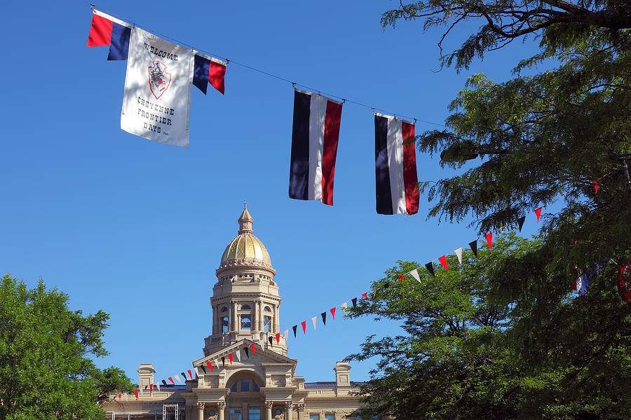 State Capitol of Wyoming and colorful flags Photograph by Rainer Grosskopf