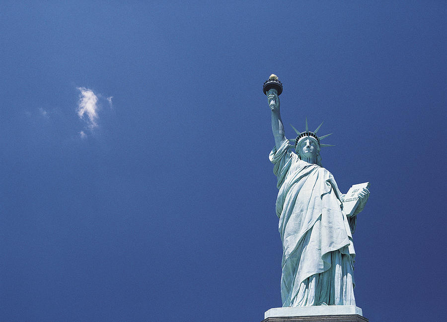 Statue of Liberty against a blue sky, New York, USA Photograph by Martin Child