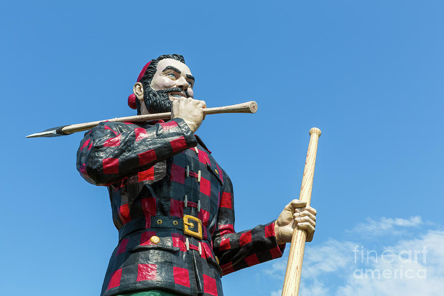 Statue of the legendary character Paul Bunyan, a mythical giant lumberjack, against blue sky on a summer day. Bangor, Maine, USA Photograph by Jane Rix