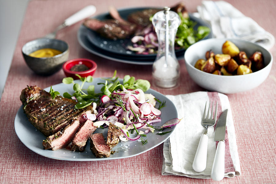 Steak meal for two on table Photograph by Debby Lewis-Harrison