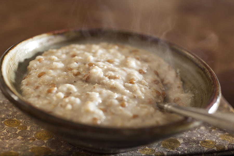 Steaming bowl of oatmeal porridge Photograph by Jon Lovette