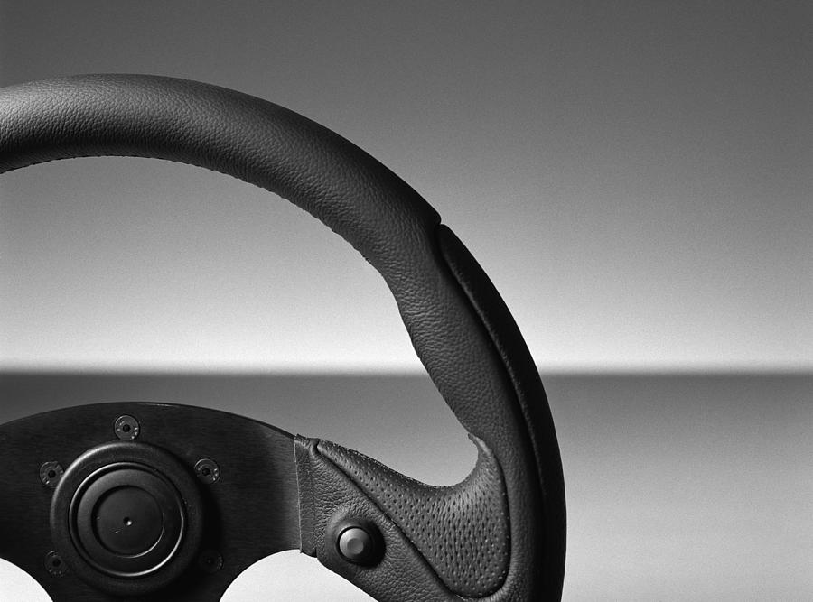 Steering wheel, close-up, b&w Photograph by Christian Zachariasen