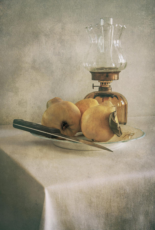 Still life with plate of fresh quinces and oil lamp Photograph by Jaroslaw Blaminsky