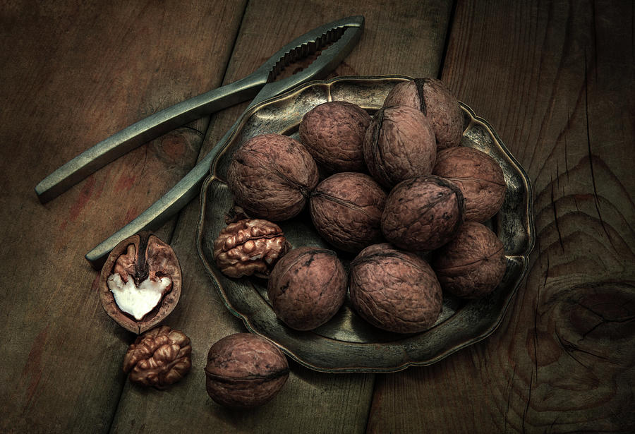 Still life with tasty walnuts a wooden table Photograph by Jaroslaw Blaminsky