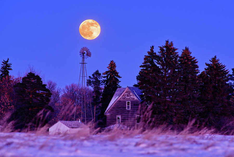 Still Turning -  Windmill, Farmhouse, and Moonrise in rural ND Photograph by Peter Herman