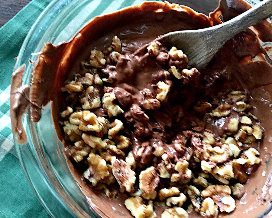 Stirring walnuts into melted chocolate Photograph by Nebari