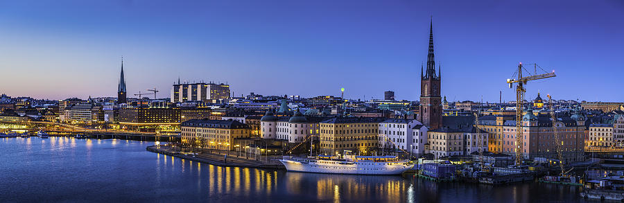 Stockholm Gamla Stan waterfront panorama illuminated at dusk Sweden Photograph by fotoVoyager