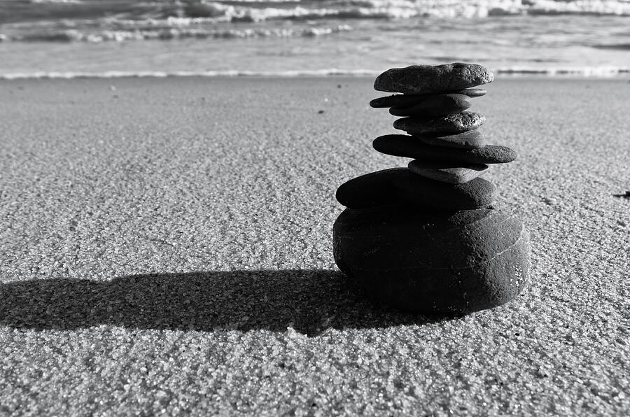 Stone balance on the beach in Monochrome Photograph by Angelo DeVal