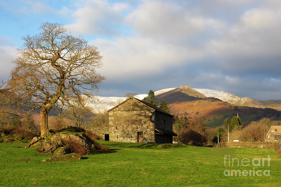 Stone barn and snow topped mountains in Ambleside Lake District Photograph by Louise Heusinkveld