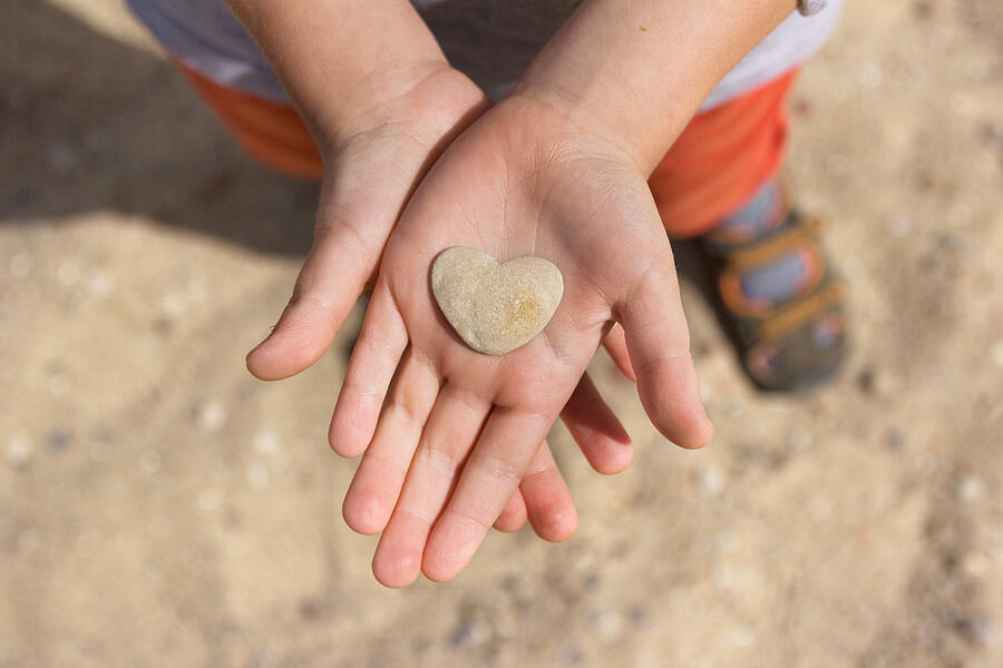 Stone heart in hands Photograph by Dmark