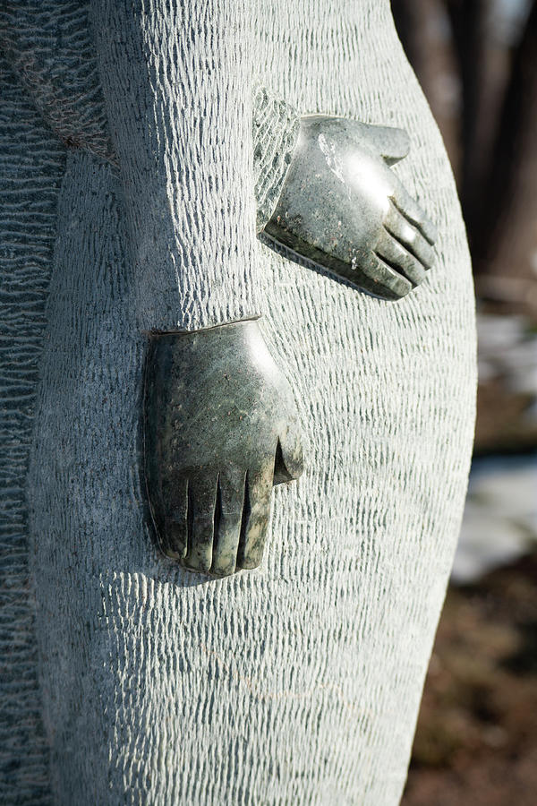 Stone Sculpture Hands Around Photograph