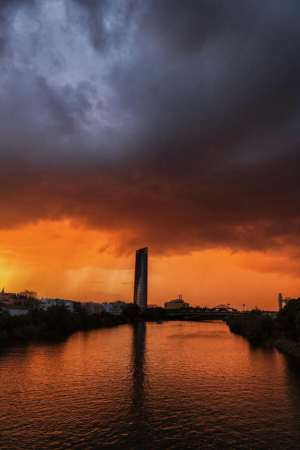 Storm Clouds Above Guadalquivir River In Seville Photograph by Artur ...