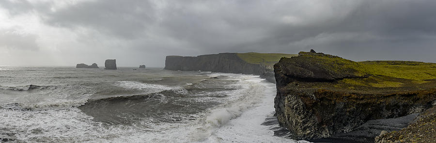 Storm clouds over Dyrholaey black basalt sand beach and cliffs Photograph by Sjo