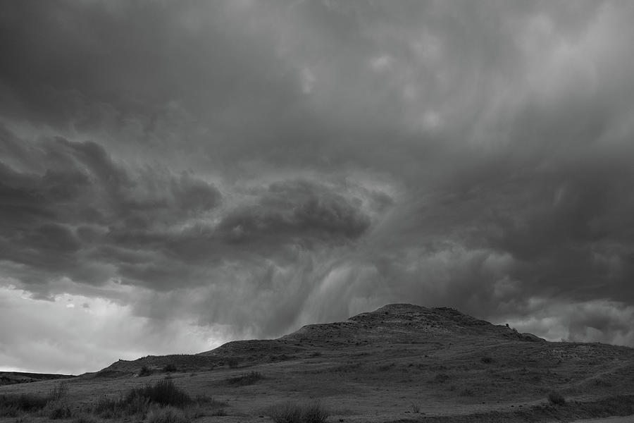 Storm clouds over mountain at Theodore Roosevelt National Park in North Dakota in black and white Photograph by Eldon McGraw