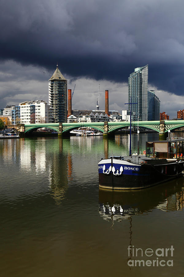 Storm clouds over River Thames and Battersea Rail Bridge London UK Photograph by James Brunker