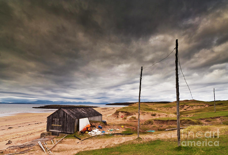 Stormy sky and abandoned fishing hut, Red point beach, Wester Ross, Scotland Photograph by Neale And Judith Clark