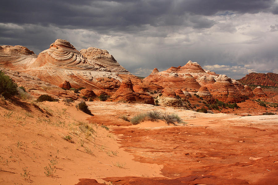 Stormy sky over the striped teepees, North Coyote Buttes Photograph by by Mike Lyvers