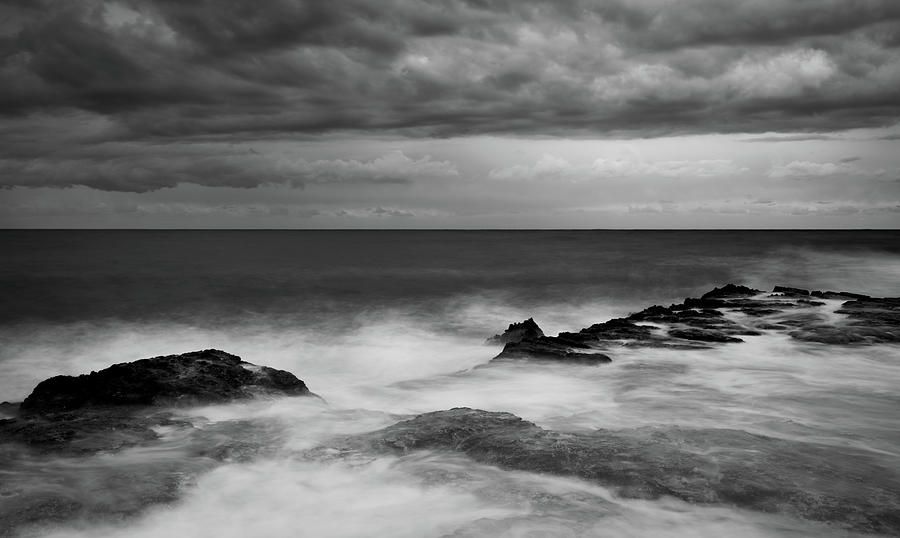 Stormy waves crashing on a rocky shore. Cloudy sky dangerous sea Photograph by Michalakis Ppalis