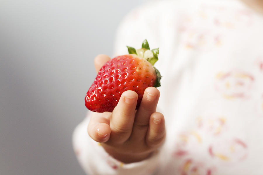 Strawberry in hand Photograph by photographed by Sandra Arduini