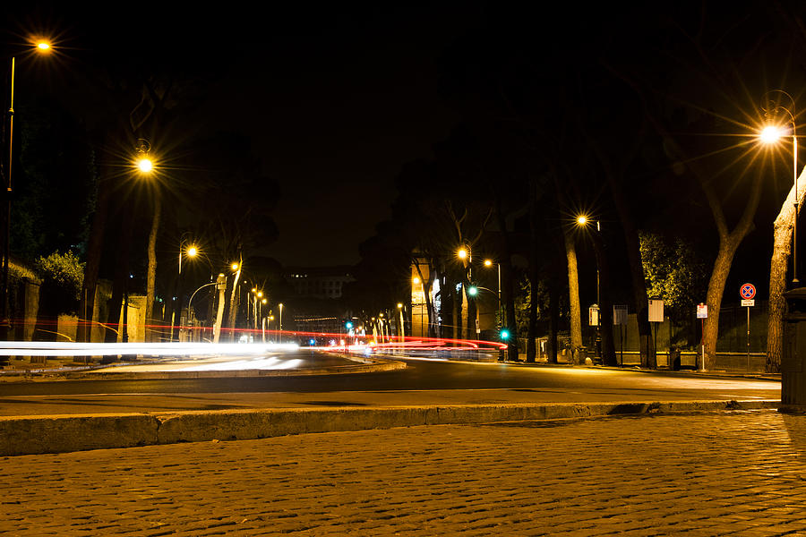street in Rome at night with light trails Photograph by Ermetico72