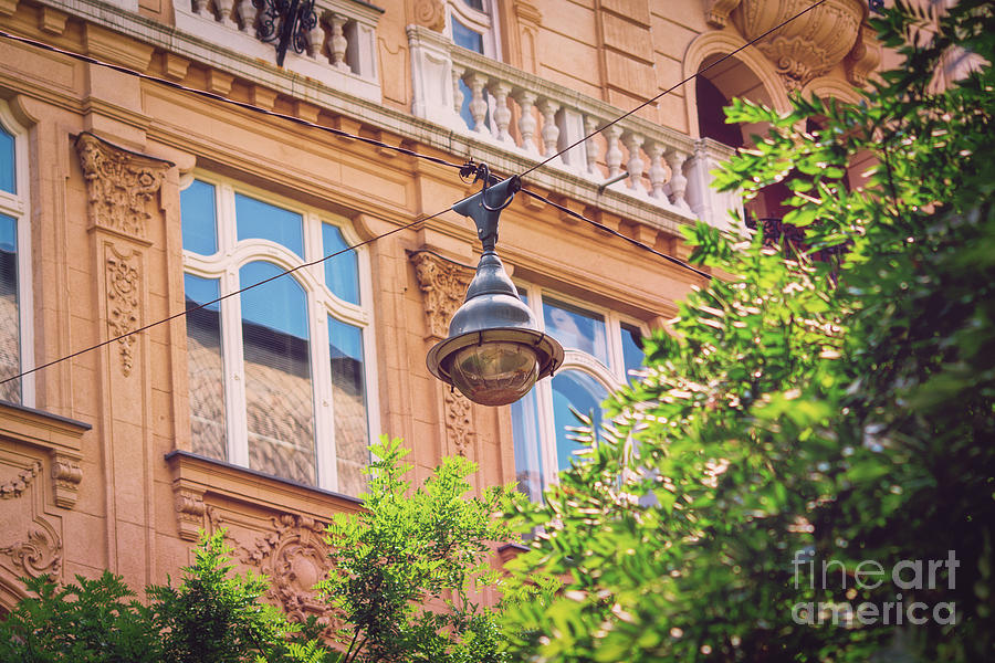 Street lamp on aerial wires and a beautiful old building Photograph by Mendelex Photography