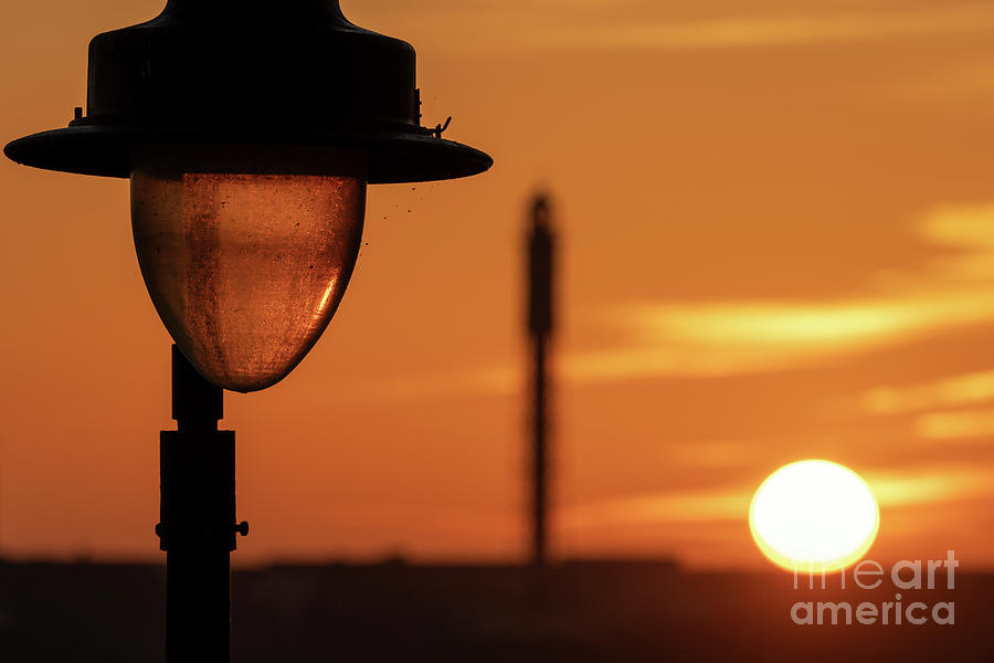 Street Lamp Silhouetted against Dramatic Orange Red Sky at Sunset La Caleta Cadiz Photograph by Pablo Avanzini