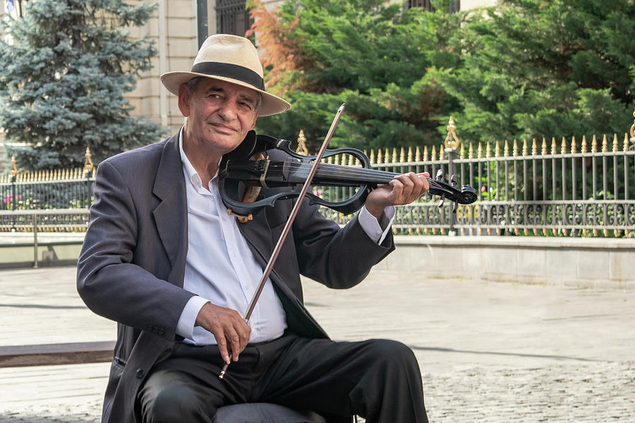 Architecture Photograph - Street Musician in the Old Town of Bucharest, Romanis by Barry O Carroll