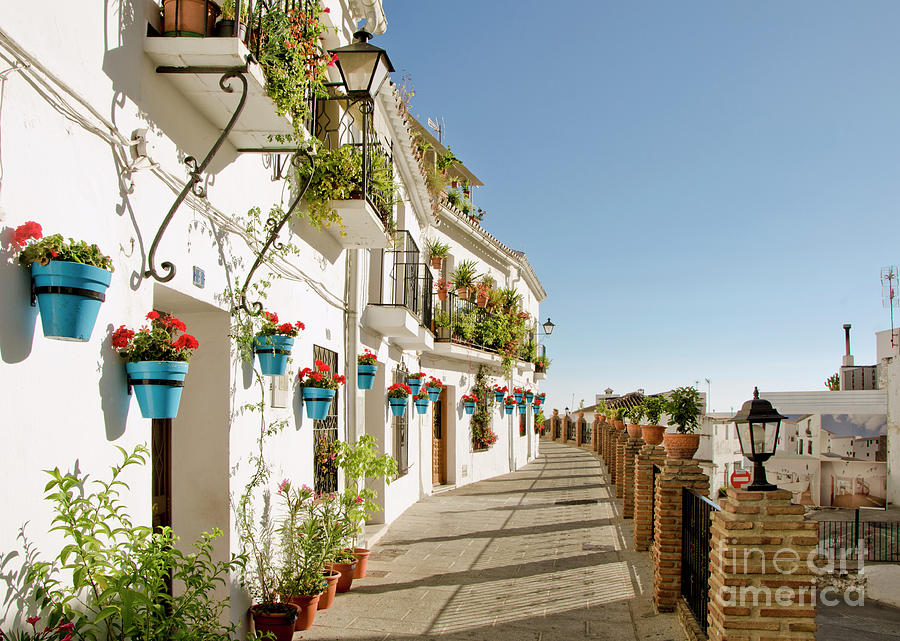 Street view of the white washed village of Mijas Pueblo Photograph by Perry Van Munster