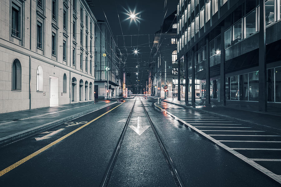 Streets of Geneva downtown by rainy night Photograph by Benoit Bruchez