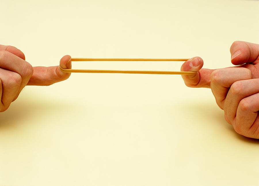 Stretching rubber band Photograph by Image Source