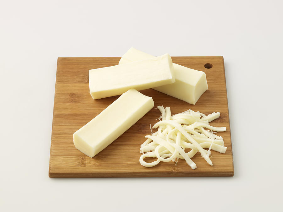 String Cheese On Chopping Board Photograph by Servet Yigit