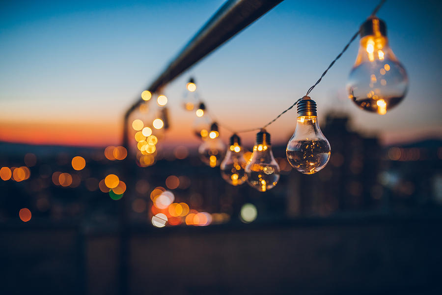 String light bulbs at sunset Photograph by Urbazon