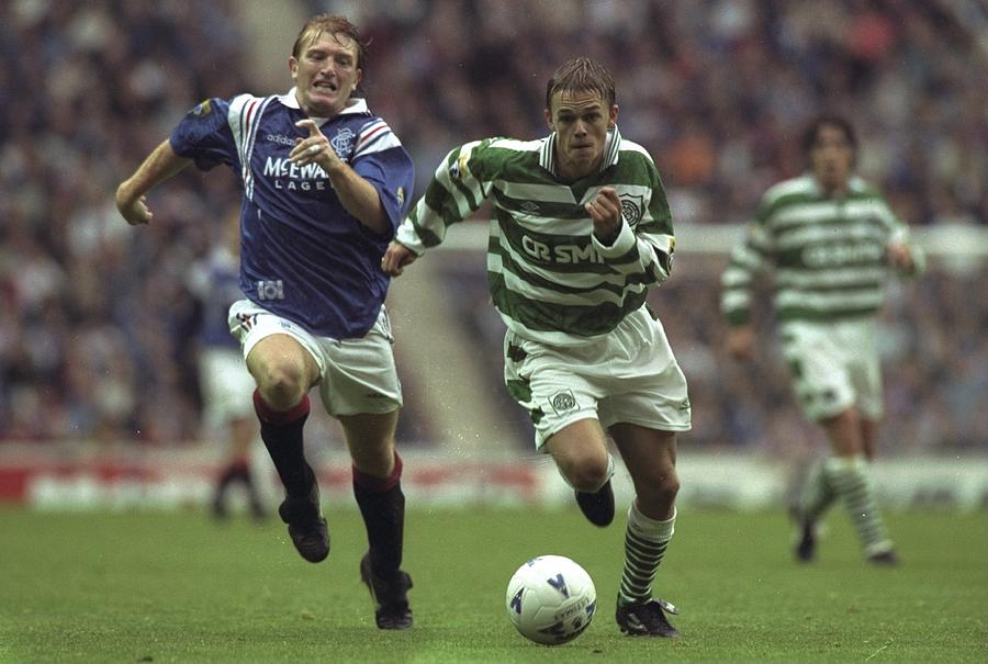 Stuart McCall (left)of Glasgow Rangers and Simon Donnelly (right) of  Celtic running after the ball Photograph by Getty Images