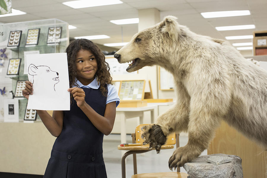 Student holding drawing of bear in museum Photograph by Hill Street Studios