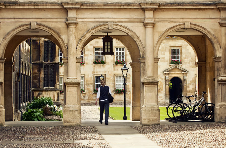 Student passing through a college campus in Cambridge Universitiy, UK Photograph by Burcintuncer