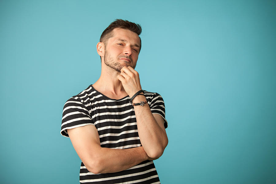 Studio portrait of a 40 year old bearded man in a striped t-shirt on a blue background Photograph by Brusinski