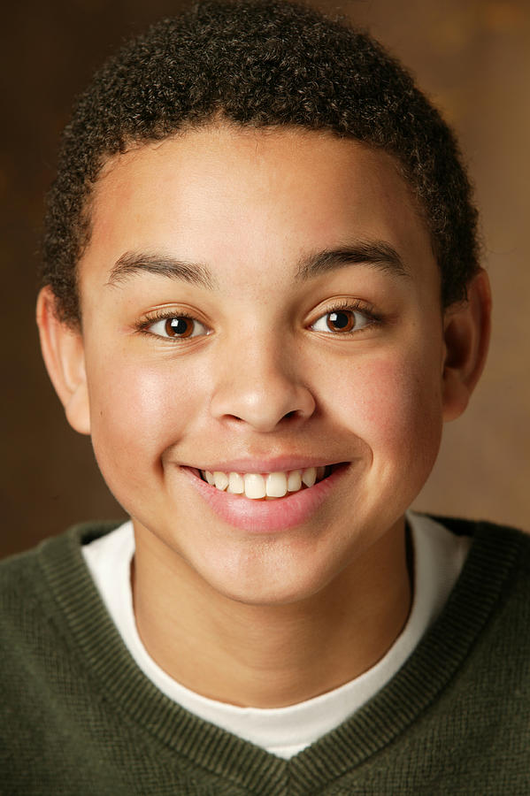 Studio Portrait Of An African American Male Teen As He Smiles Brightly Photograph by Photodisc