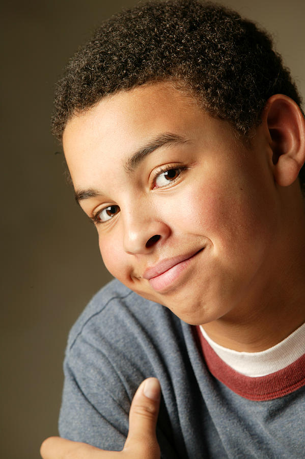 Studio Portrait Of An African American Male Teen As He Smirks At The Camera Photograph by Photodisc