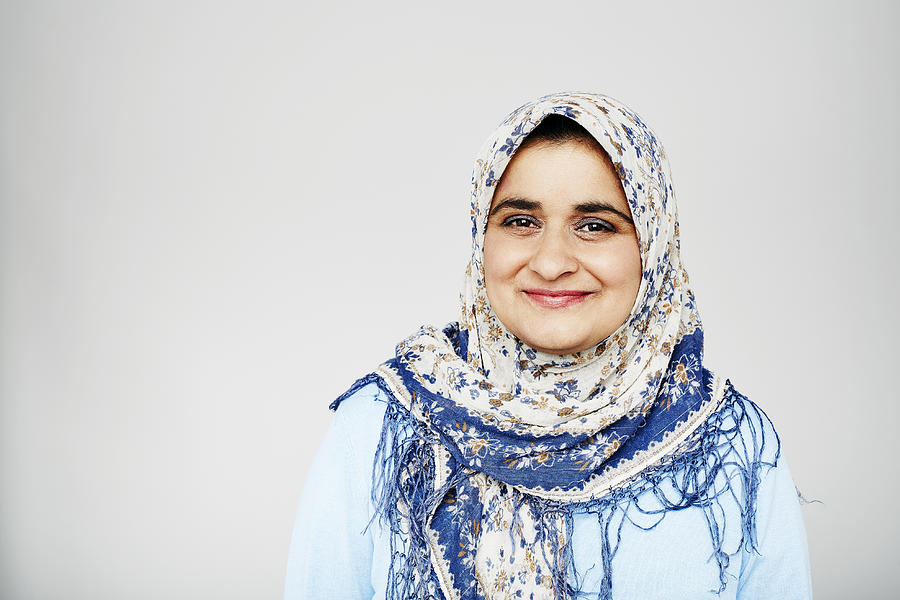 Studio portrait of muslim woman smiling to camera Photograph by Kelvin Murray