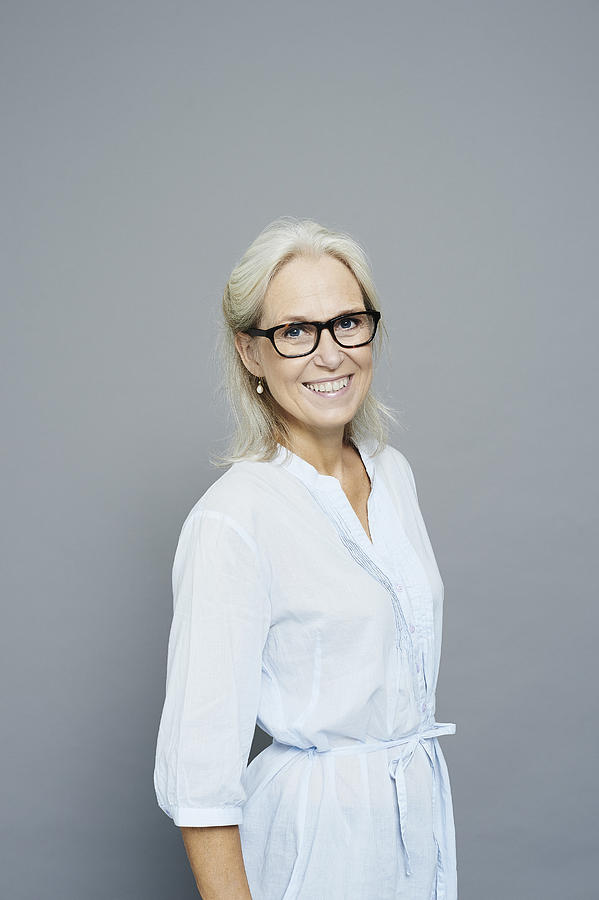Studio portrait of smiling mature businesswoman Photograph by Jakob Helbig