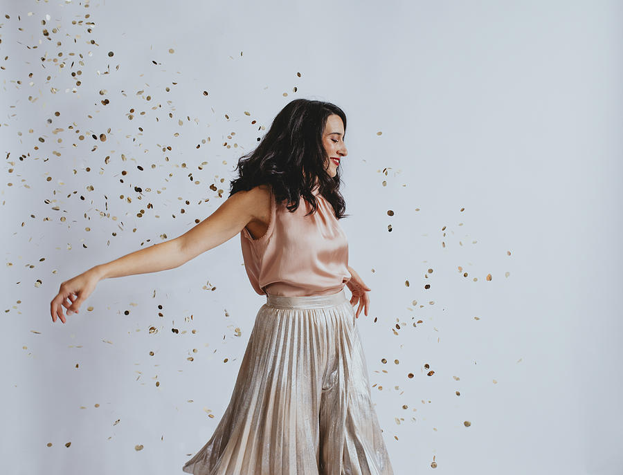 Studio Shopt of a Beautiful Smiling Elegant Woman Dancing Showered With Confetti Photograph by FreshSplash
