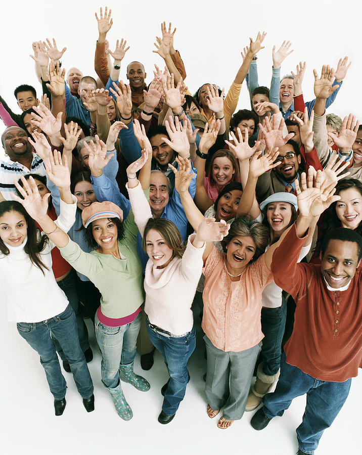 Studio Shot of a Large Mixed Age, Multiethnic Group of Men and Women Cheering With Their Arms in the Air Photograph by Digital Vision.