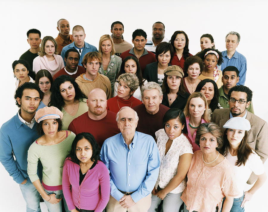 Studio Shot of a Large Mixed Age, Multiethnic Group of Men and Women Staring at the Camera in a Displeased Way Photograph by Digital Vision.
