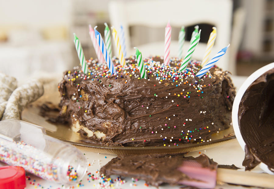 Studio Shot of chocolate birthday cake Photograph by Jamie Grill