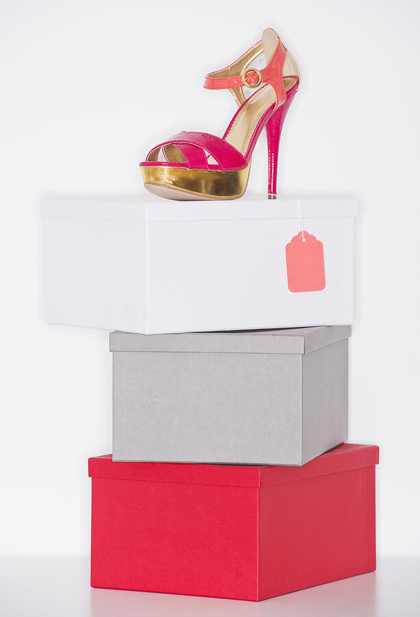 Studio shot of dress shoe on top of stack of boxes Photograph by Daniel Grill