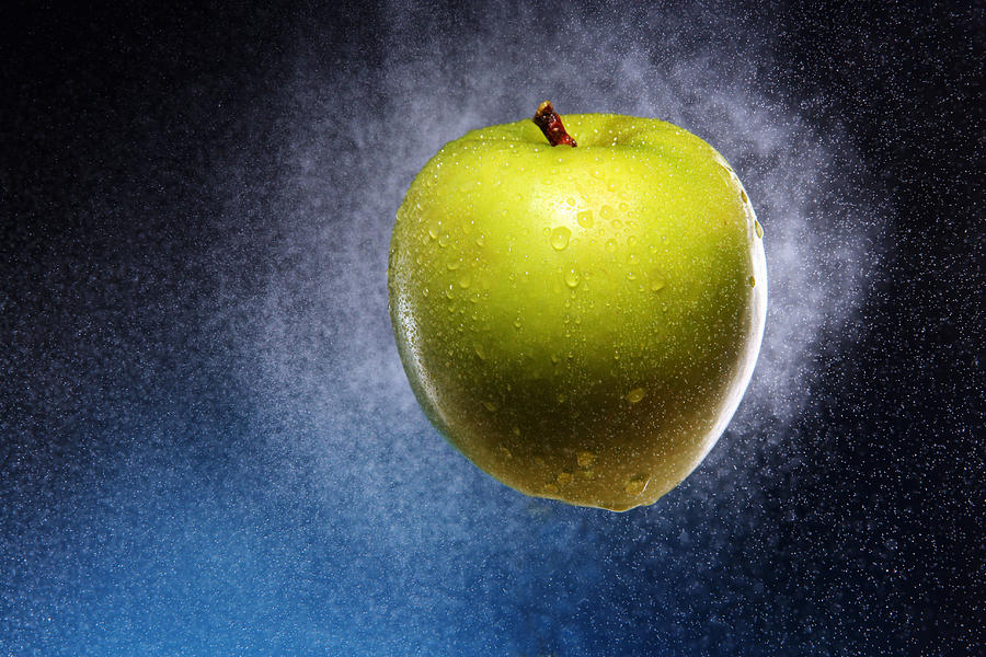 Studio shot of green apple with drops and spray Photograph by Scott Kleinman
