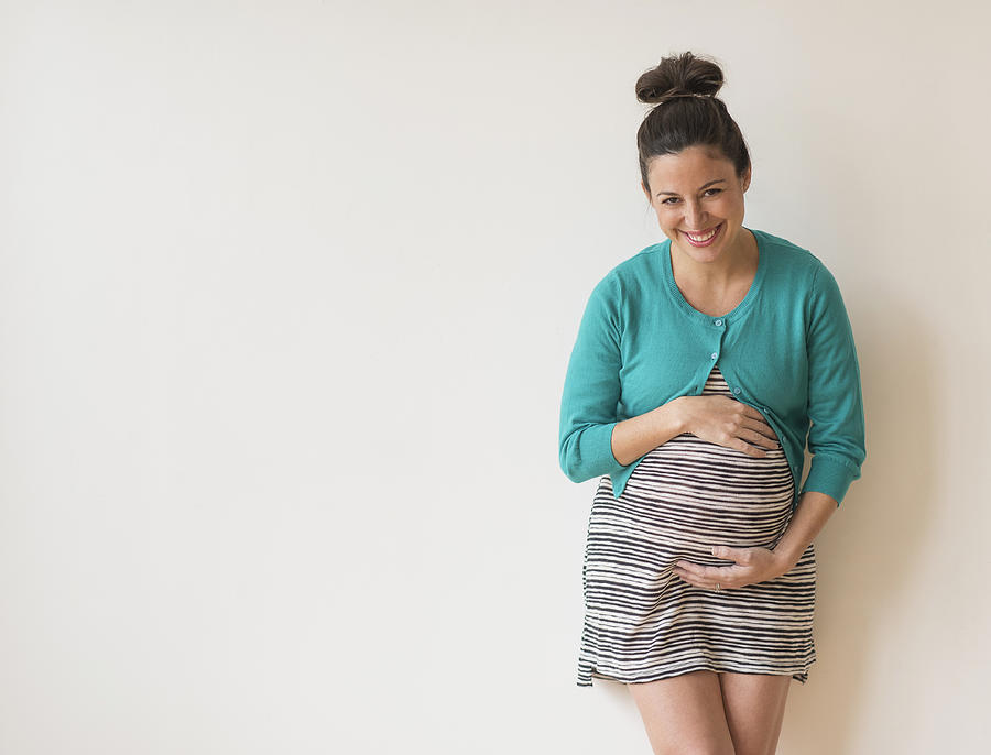 Studio shot of happy pregnant woman Photograph by Tetra Images